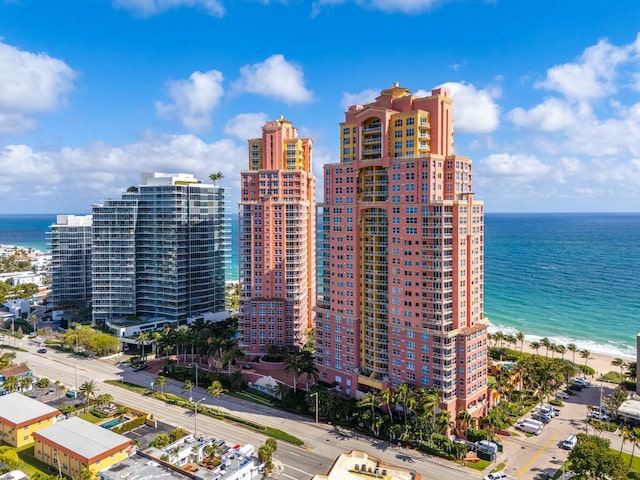 exterior space with a water view and a view of the beach