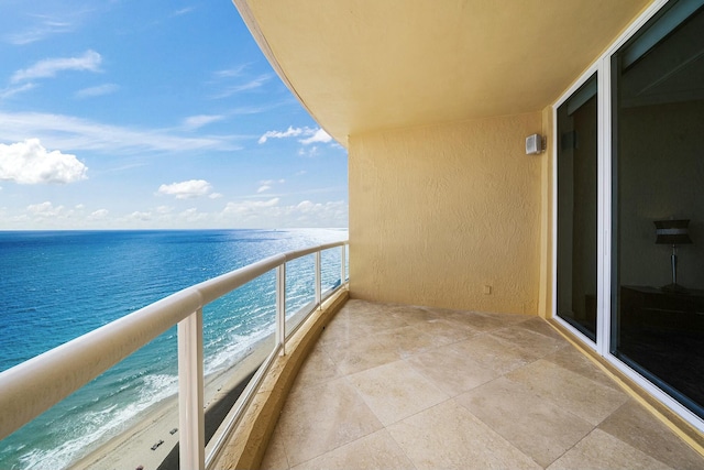 balcony with a beach view and a water view