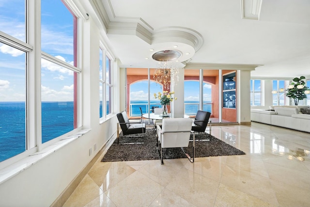 sunroom / solarium featuring a water view and a chandelier