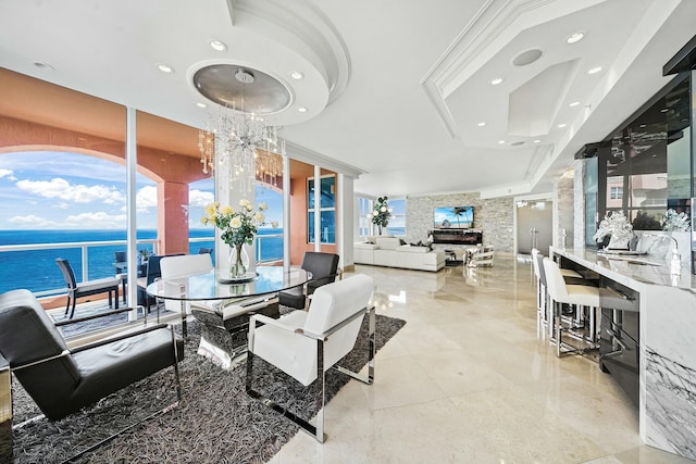 dining room featuring a chandelier and a water view