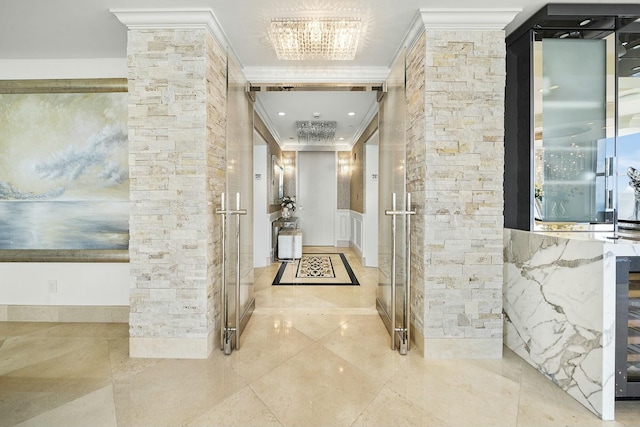 hallway with ornamental molding and an inviting chandelier