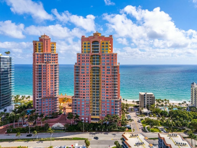 exterior space with a water view and a beach view