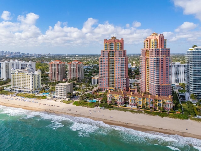 drone / aerial view with a water view and a beach view