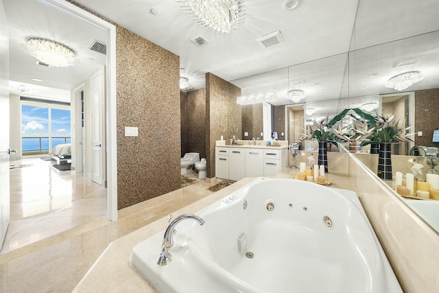 bathroom with vanity, a washtub, toilet, a bidet, and a water view