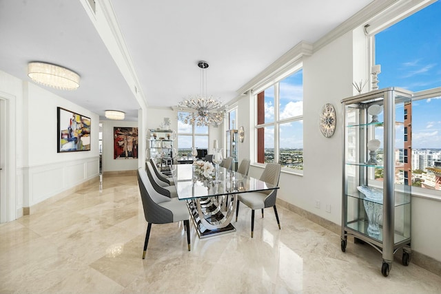 dining space with crown molding and a notable chandelier