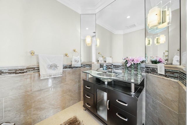 bathroom featuring tile walls, vanity, and crown molding