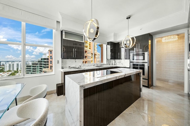 kitchen featuring plenty of natural light, hanging light fixtures, a center island, light stone countertops, and black electric cooktop