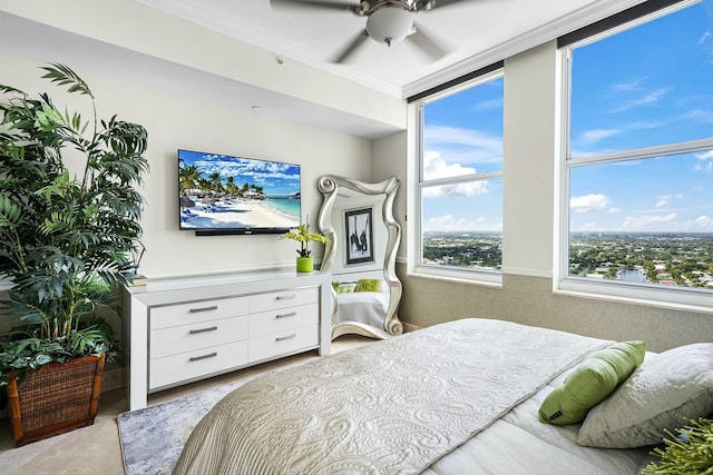 bedroom with ornamental molding and ceiling fan