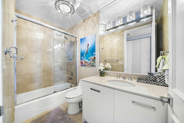 full bathroom with vanity, toilet, and combined bath / shower with glass door