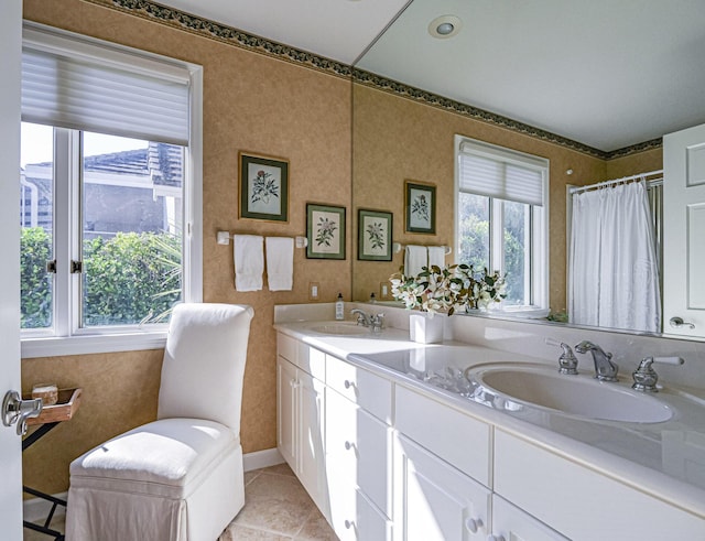 bathroom with a shower with curtain, vanity, and tile patterned flooring