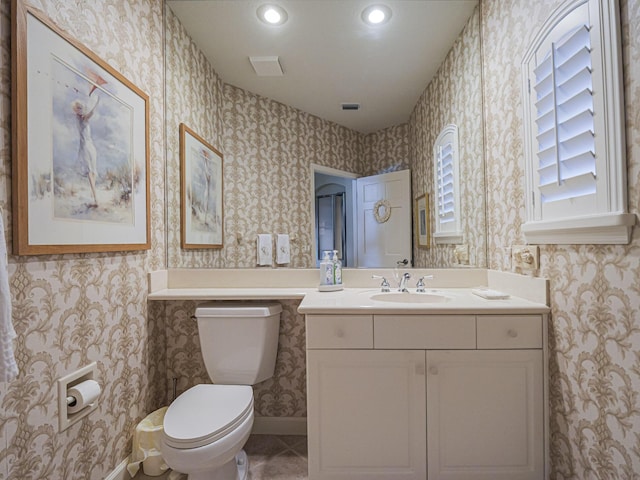 bathroom with vanity, tile patterned flooring, and toilet