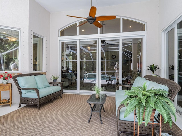 sunroom / solarium featuring ceiling fan