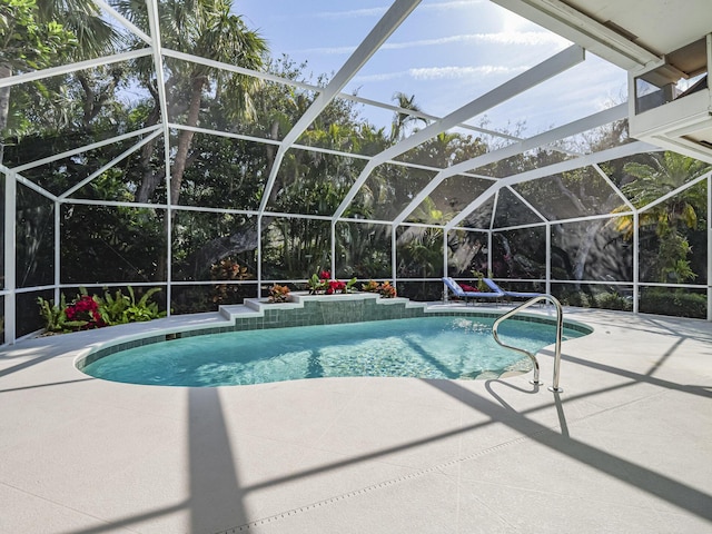 view of pool featuring a patio area and glass enclosure