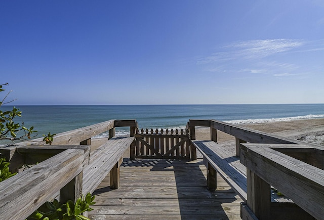 surrounding community featuring a water view and a view of the beach