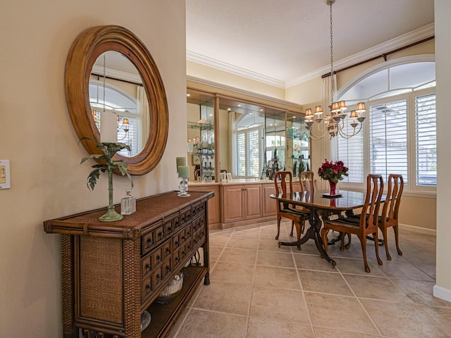 tiled dining room with crown molding and a chandelier