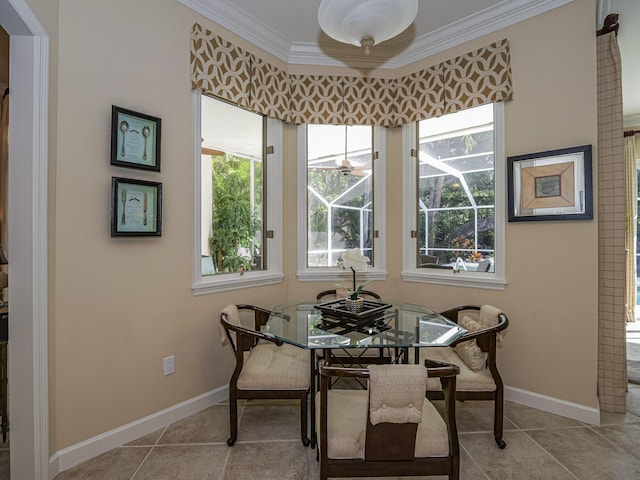 tiled dining area featuring crown molding and a wealth of natural light