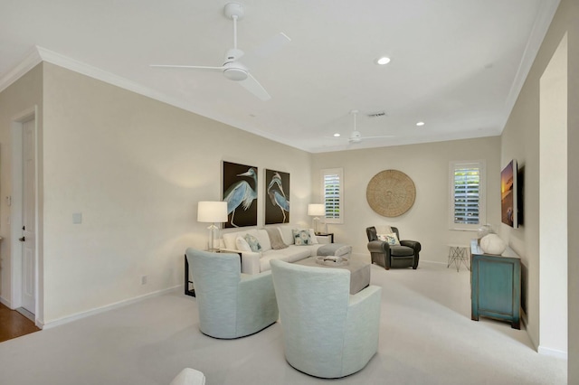 living room with ornamental molding, plenty of natural light, light carpet, and ceiling fan