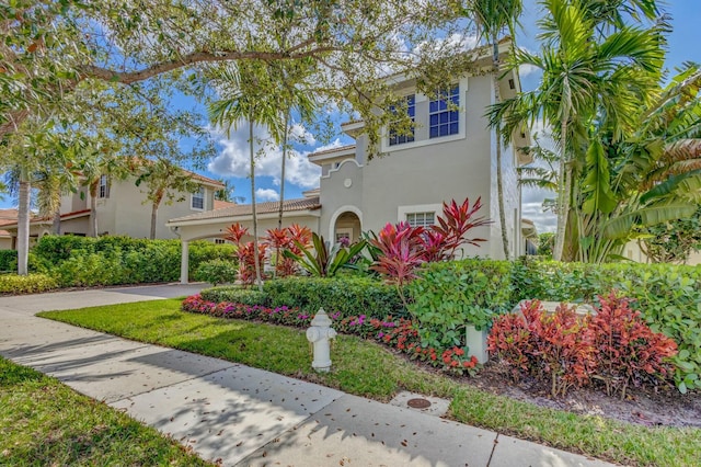 mediterranean / spanish-style home with a front yard