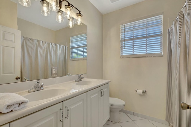 bathroom with tile patterned floors, toilet, curtained shower, and vanity