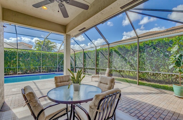 view of patio / terrace with ceiling fan and glass enclosure