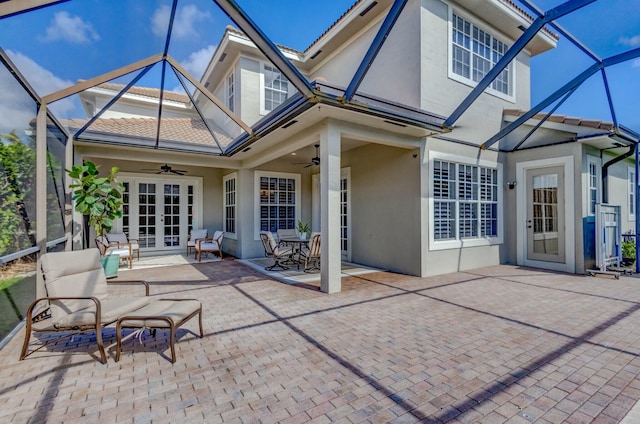 exterior space with ceiling fan and glass enclosure