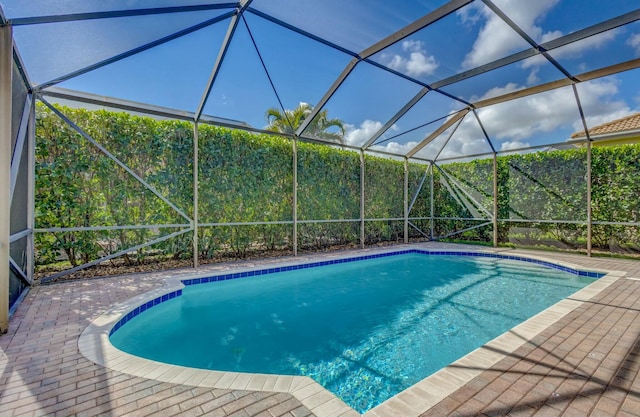 view of pool featuring a patio and glass enclosure