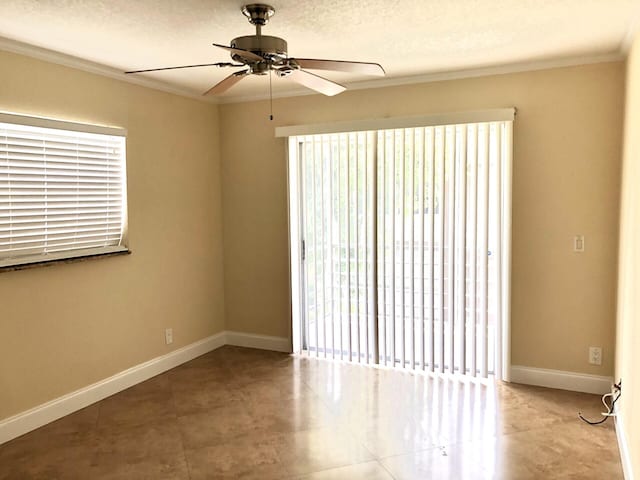 spare room with ceiling fan, crown molding, and a textured ceiling