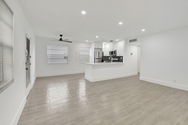 unfurnished living room featuring recessed lighting, visible vents, ceiling fan, and light wood-style flooring