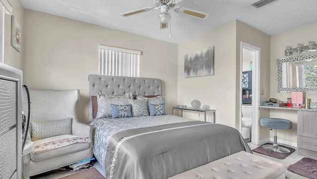 bedroom featuring ceiling fan, a textured ceiling, and ensuite bathroom