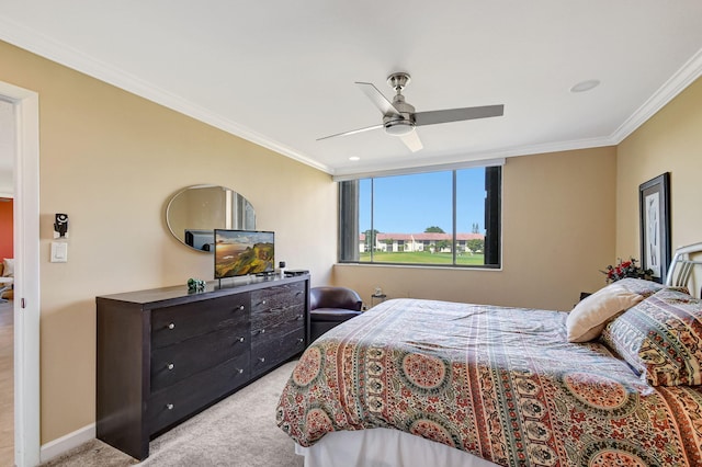 carpeted bedroom with ornamental molding and ceiling fan