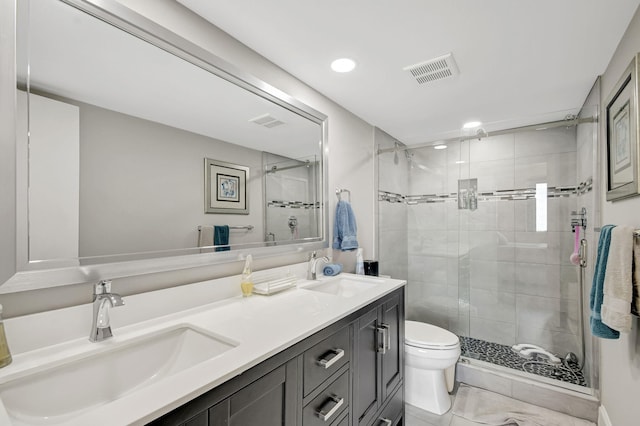 bathroom with vanity, a shower with door, and toilet