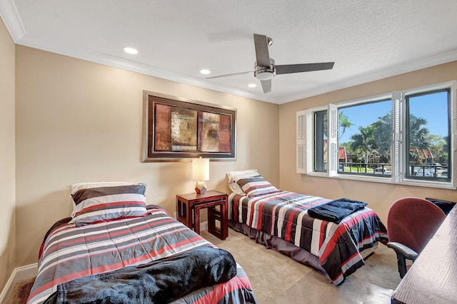 bedroom with ornamental molding, light colored carpet, and ceiling fan