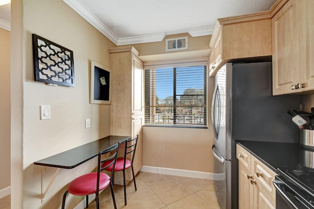 kitchen with crown molding, light brown cabinets, built in desk, and light tile patterned floors