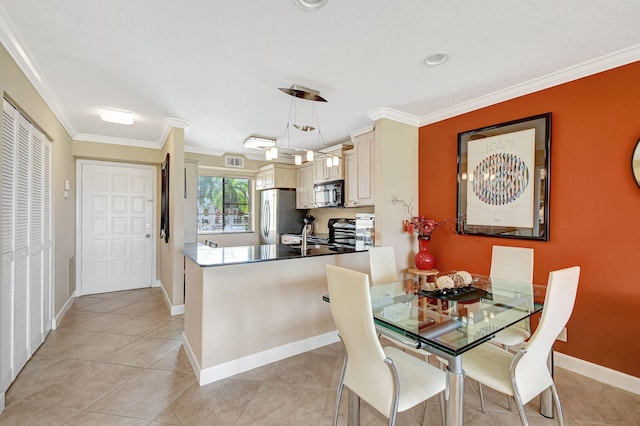 dining space with light tile patterned floors and crown molding