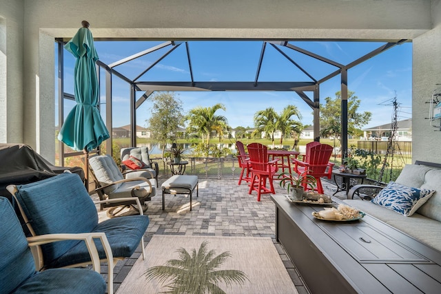 view of patio / terrace with an outdoor hangout area and glass enclosure