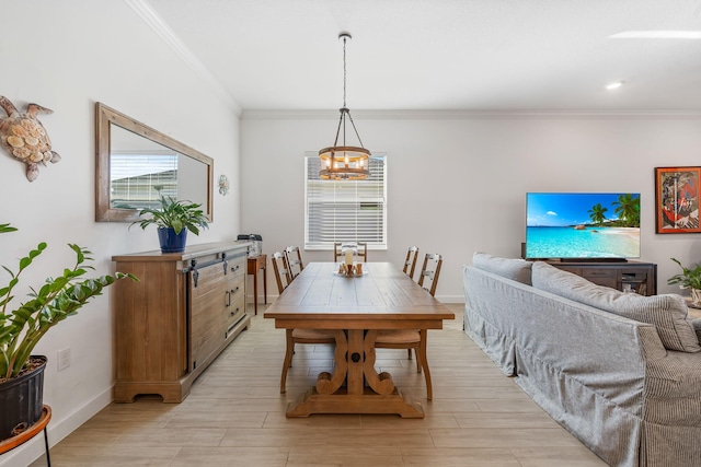 dining space featuring ornamental molding, a chandelier, and light hardwood / wood-style floors