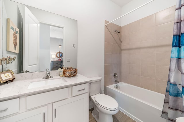 full bathroom with shower / tub combo with curtain, vanity, and toilet