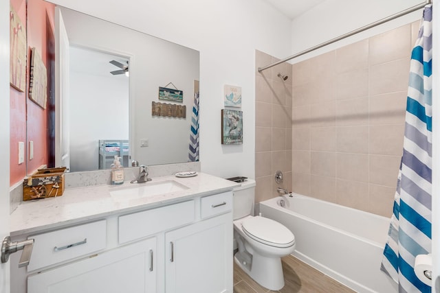 full bathroom with toilet, vanity, shower / bath combo with shower curtain, hardwood / wood-style flooring, and ceiling fan