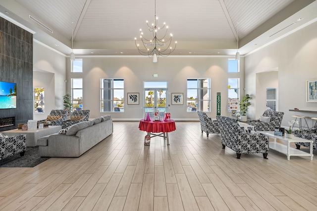 living room featuring a notable chandelier, wood ceiling, and light hardwood / wood-style flooring