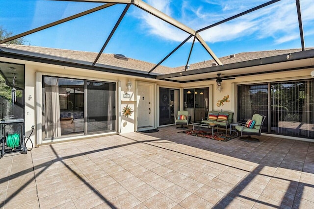 exterior space featuring ceiling fan and glass enclosure