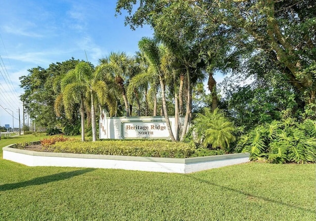 community / neighborhood sign with a lawn