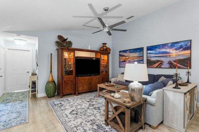 living room with ceiling fan, lofted ceiling, and light wood-type flooring