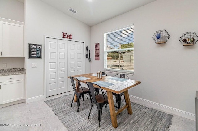 dining area with lofted ceiling