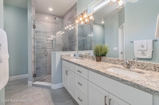 bathroom featuring a shower with door and vanity