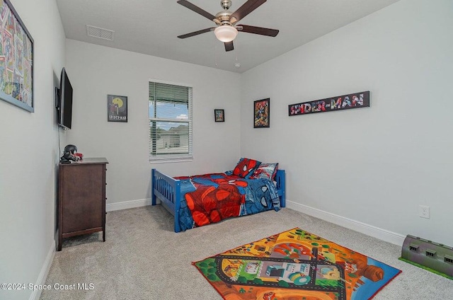 bedroom with ceiling fan and light carpet