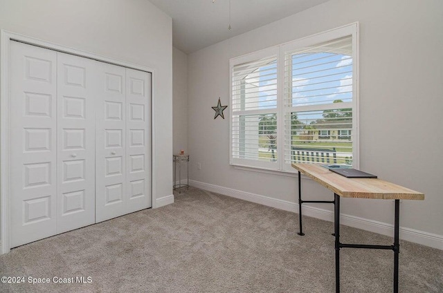 carpeted office space with vaulted ceiling