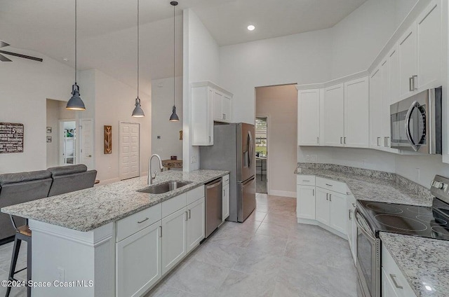 kitchen with sink, white cabinetry, decorative light fixtures, a kitchen breakfast bar, and stainless steel appliances