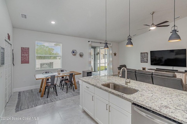 kitchen featuring decorative light fixtures, white cabinetry, sink, stainless steel dishwasher, and light stone counters