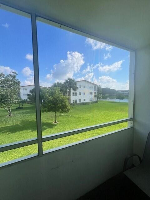 unfurnished sunroom with a water view