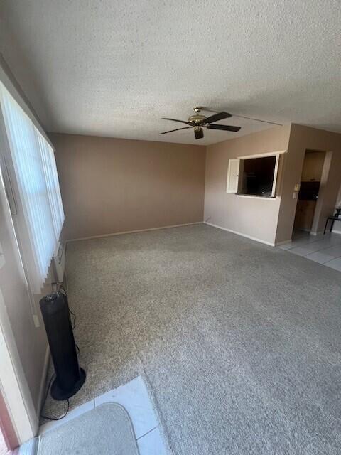 unfurnished room featuring a textured ceiling and ceiling fan